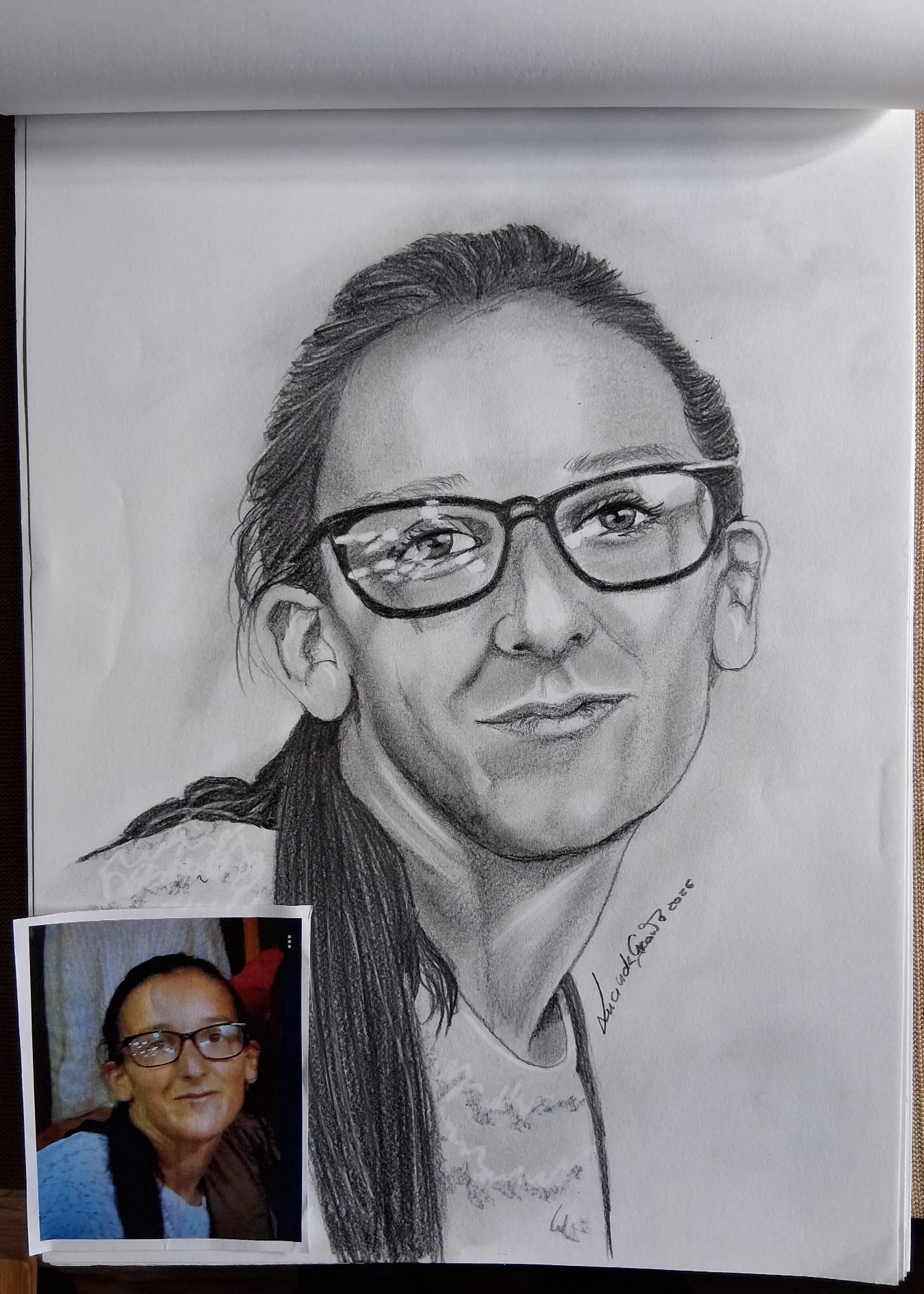 Charcoal portrait of a woman with glasses